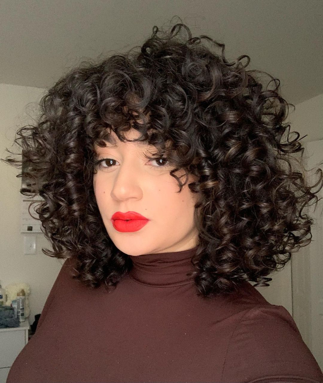 19 Best Curly Bobs With Bangs For The Most Flattering Haircut & Hairstyle