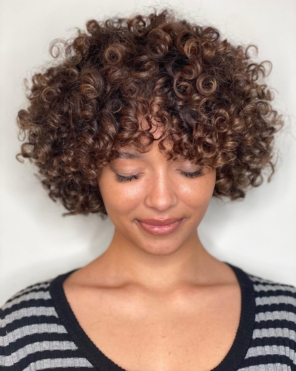 19 Best Curly Bobs With Bangs For The Most Flattering Haircut & Hairstyle